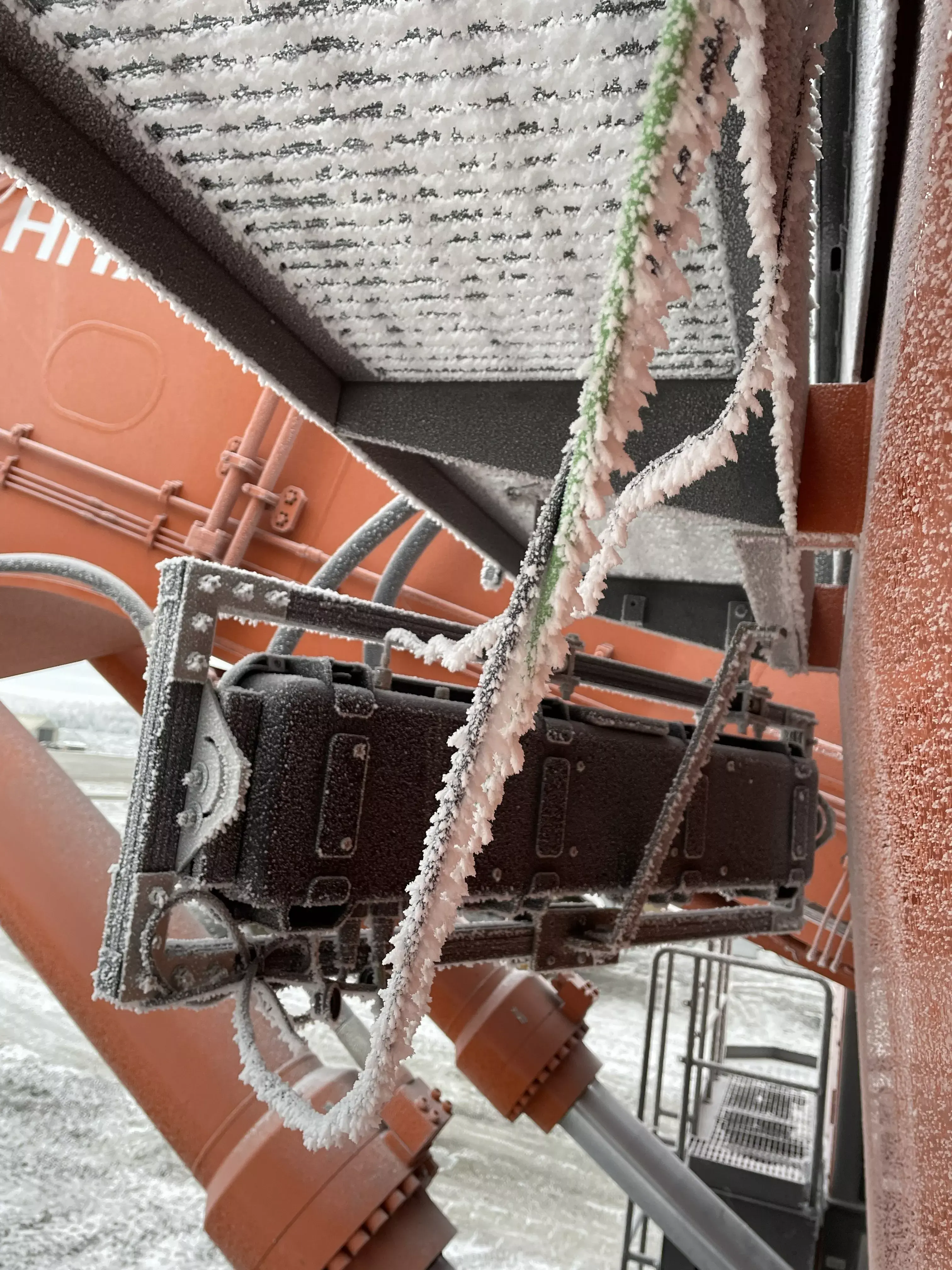 Mining excavator bucket with ground-engaging tools during field validation in Finland.