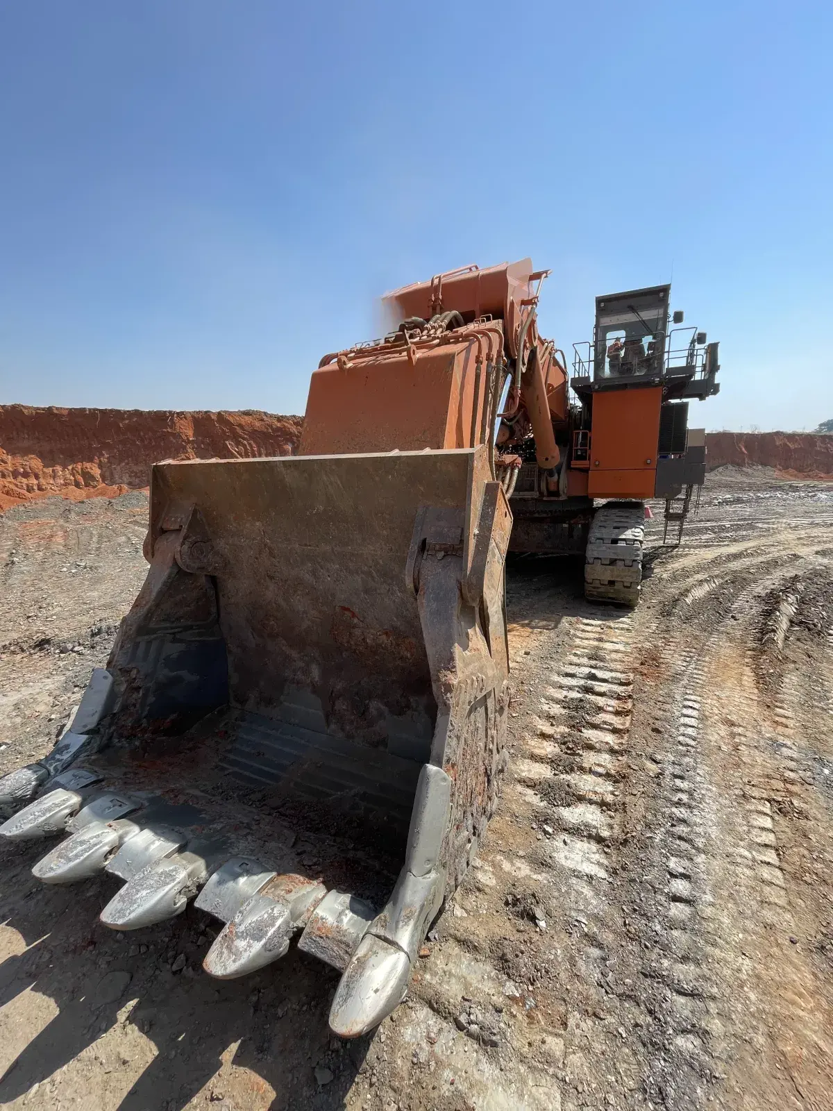 Close frontal view of a large mining excavator and bucket in an open-cut mine, illustrating machine scale and field conditions.